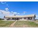Expansive single-story home featuring red shutters, a metal roof, and a manicured front lawn at 30999 Kootney St, Elizabeth, CO 80107