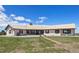Lovely exterior of single-story home showing red shutters, a metal roof, and a spacious front lawn at 30999 Kootney St, Elizabeth, CO 80107