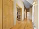 Hallway featuring natural wood flooring and paneled doors at 30999 Kootney St, Elizabeth, CO 80107