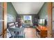Cozy living room with a leather couch, hardwood floors, and a stunning view from the window at 30999 Kootney St, Elizabeth, CO 80107