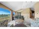 Spacious living room featuring vaulted ceilings, large windows with scenic views, and a comfortable seating area at 30999 Kootney St, Elizabeth, CO 80107