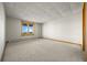 Empty room with neutral carpet, walls, and trim, featuring a window with a scenic view at 30999 Kootney St, Elizabeth, CO 80107