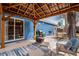 Backyard featuring a covered pergola, outdoor seating and a blue house at 6445 Second St, Louviers, CO 80131