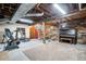 Unfinished basement featuring exposed beams and areas for music and fitness activities at 6445 Second St, Louviers, CO 80131