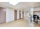 Unfinished basement space featuring geometric linoleum flooring and ample storage along the walls at 6445 Second St, Louviers, CO 80131