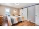 Bedroom features laminate floors, barn door, and access to closet space at 6445 Second St, Louviers, CO 80131