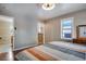 Comfortable bedroom with a striped comforter, a window and easy access to the bathroom at 6445 Second St, Louviers, CO 80131
