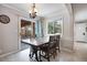 Sunny dining room with wood table, tile floors, and sliding door access at 6445 Second St, Louviers, CO 80131