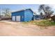 Exterior of the home with a detached garage and outdoor living space at 6445 Second St, Louviers, CO 80131