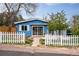 Charming blue home features a white picket fence and inviting front yard at 6445 Second St, Louviers, CO 80131