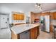 Open kitchen with island, stainless appliances, and plenty of cabinet space at 6445 Second St, Louviers, CO 80131
