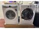 Modern laundry area features a white Electrolux washer and dryer for convenient home living at 6445 Second St, Louviers, CO 80131