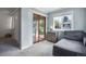 Cozy living room with sliding glass doors, soft carpet, and tranquil atmosphere at 6445 Second St, Louviers, CO 80131