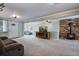 Inviting living room boasts stone fireplace, plush carpets, and natural light at 6445 Second St, Louviers, CO 80131