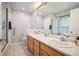 Bathroom boasts double sink vanity, tile flooring, and a framed glass shower at 23612 Pondview Pl # A, Golden, CO 80401