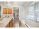 Bathroom showcases a vanity, bathtub and shower with glass panel at 23612 Pondview Pl # A, Golden, CO 80401