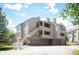 Beautiful condominium building with multiple levels, garages, private balconies, and staircase access at 23612 Pondview Pl # A, Golden, CO 80401