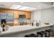 Bright kitchen features stainless steel appliances, wood cabinets and eat-in counter with bar stool seating at 23612 Pondview Pl # A, Golden, CO 80401