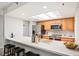 Bright kitchen features stainless steel appliances, wood cabinets and eat-in counter with bar stool seating at 23612 Pondview Pl # A, Golden, CO 80401
