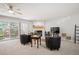 Bright living room with fireplace, neutral carpet and access to outside balcony at 23612 Pondview Pl # A, Golden, CO 80401