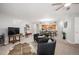 Bright living room with fireplace, neutral carpet and open access to kitchen at 23612 Pondview Pl # A, Golden, CO 80401
