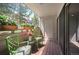 Charming balcony with green seating, wood flooring, and outdoor plants at 23612 Pondview Pl # A, Golden, CO 80401
