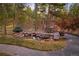 Backyard patio features a rock-rimmed pond and outdoor seating in a tranquil wooded setting at 646 Ruby Trust Dr, Castle Rock, CO 80108