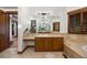 Bathroom with a spacious vanity, a large mirror, tiled floors, and warm wooden accents at 646 Ruby Trust Dr, Castle Rock, CO 80108