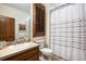 Charming bathroom featuring wood vanity, patterned shower curtain, and natural light at 646 Ruby Trust Dr, Castle Rock, CO 80108