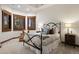 Comfortable bedroom with a decorative bed frame and natural light from wood-framed windows at 646 Ruby Trust Dr, Castle Rock, CO 80108