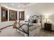 Cozy bedroom featuring a metal frame bed, accent pillows, and bright windows with wood shutters at 646 Ruby Trust Dr, Castle Rock, CO 80108