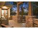 Covered patio with stone pillars and a seating area for enjoying the outdoors at 646 Ruby Trust Dr, Castle Rock, CO 80108