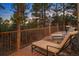 Large outdoor deck with lounge chairs overlooking a scenic forest view at 646 Ruby Trust Dr, Castle Rock, CO 80108