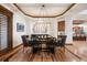 Dining room boasts hardwood floors, tray ceiling, and modern lighting fixture at 646 Ruby Trust Dr, Castle Rock, CO 80108