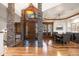 Inviting entryway with stone pillars, wood accents, tiled floor, and dining area with chandelier at 646 Ruby Trust Dr, Castle Rock, CO 80108