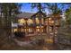 A luxurious home with multiple levels, balconies, outdoor seating, stonework and lush backyard at 646 Ruby Trust Dr, Castle Rock, CO 80108