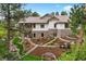 Charming stucco and stone house with tiered landscaping, a water feature, and mature trees at 646 Ruby Trust Dr, Castle Rock, CO 80108