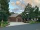Aesthetic home with a large driveway, two car garage, stone facade, and lovely landscaping at 646 Ruby Trust Dr, Castle Rock, CO 80108