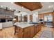 Open concept kitchen with large island, granite countertops, custom cabinets, and stainless appliances at 646 Ruby Trust Dr, Castle Rock, CO 80108