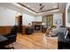 Cozy living room with stone fireplace, comfortable seating, and built-in bookshelves at 646 Ruby Trust Dr, Castle Rock, CO 80108
