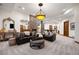 Spacious living room with a stone fireplace, modern furniture, and neutral carpeting at 646 Ruby Trust Dr, Castle Rock, CO 80108