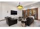 Cozy living room featuring dark leather sofas and a large flat-screen television at 646 Ruby Trust Dr, Castle Rock, CO 80108