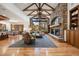Spacious living room featuring a stone fireplace, wood beams, and large windows with a view at 646 Ruby Trust Dr, Castle Rock, CO 80108