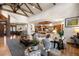Open-concept living space with a high ceiling, stone fireplace, and seamlessly connected kitchen and dining areas at 646 Ruby Trust Dr, Castle Rock, CO 80108