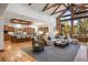 Spacious living room with a stone fireplace, hardwood floors, and large windows at 646 Ruby Trust Dr, Castle Rock, CO 80108