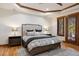 Comfortable main bedroom with wood trim, ceiling fan, and large windows with window coverings at 646 Ruby Trust Dr, Castle Rock, CO 80108