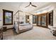Spacious bedroom featuring a four-poster bed, natural light and wood trim windows and doors at 646 Ruby Trust Dr, Castle Rock, CO 80108