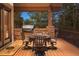 Covered outdoor patio area with table, grill, and stone accents at 646 Ruby Trust Dr, Castle Rock, CO 80108