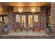 Inviting front porch with wooden rocking chairs and stone accents at 646 Ruby Trust Dr, Castle Rock, CO 80108