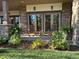 Inviting porch featuring stone accents, an outdoor seating area, and lovely landscaping at 646 Ruby Trust Dr, Castle Rock, CO 80108